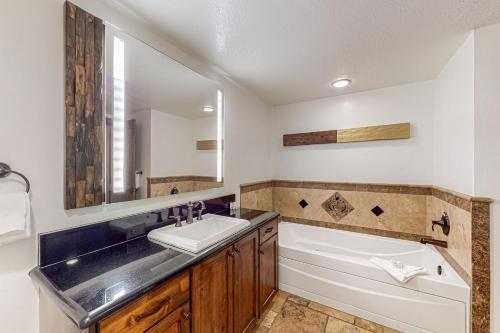 a bathroom with a sink and a bath tub at Canyons Sunrise in Park City