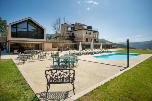 a patio with tables and chairs next to a building at Quinta de Cabanas Douro Country House in Penha Longa