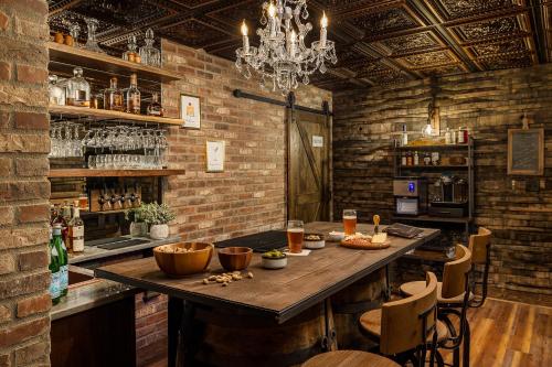 a bar with a wooden table in a brick wall at Pillow and Paddock B&B in La Grange