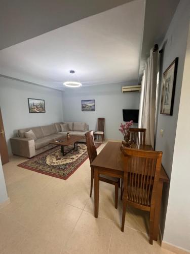 ein Wohnzimmer mit einem Tisch und einem Sofa in der Unterkunft Apartment in Skanderbeg Square - Tirana Center 2 in Tirana