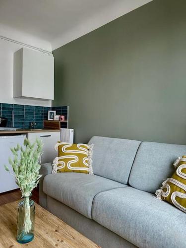 un salon avec un canapé et une table dans l'établissement Joli Studio proche Paris; Stade de France, à Saint-Denis