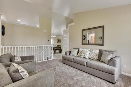 a living room with a couch and a mirror at Family-Friendly Clearfield Home with Hot Tub! in Clearfield