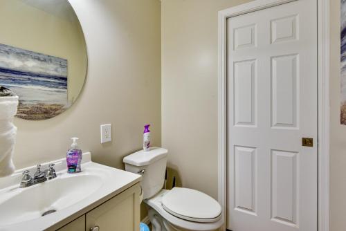 a bathroom with a toilet and a sink and a mirror at Family-Friendly Clearfield Home with Hot Tub! in Clearfield