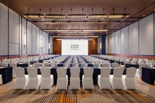 an empty conference room with a screen in the middle at Four Points by Sheraton Chongqing, Yongchuan in Yongchuan
