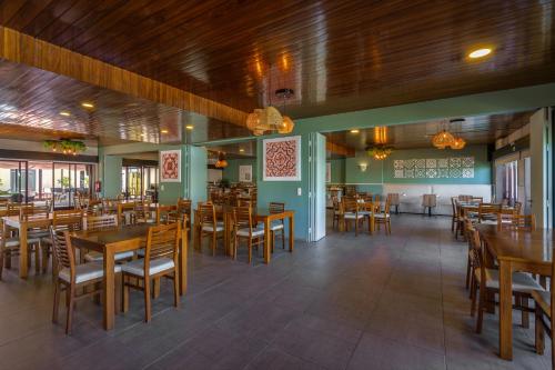a dining room with wooden tables and chairs at AquaHotel in Ovar