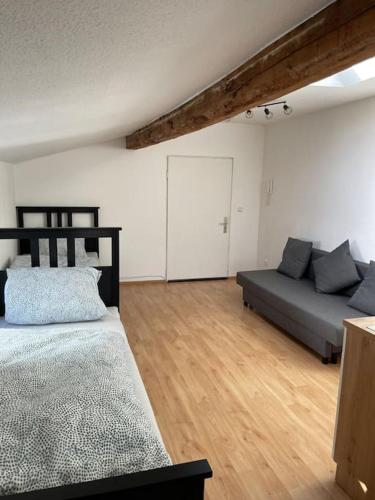 a bedroom with a bed and a couch at Zentrale Wohnung in Düren in Düren - Eifel
