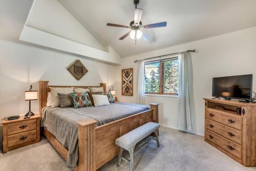 a bedroom with a bed and a flat screen tv at Bright Townhome - 1 Mile to Downtown Cloudcroft in Cloudcroft