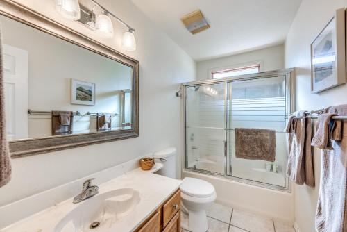 a bathroom with a sink and a toilet and a mirror at Bright Townhome - 1 Mile to Downtown Cloudcroft in Cloudcroft