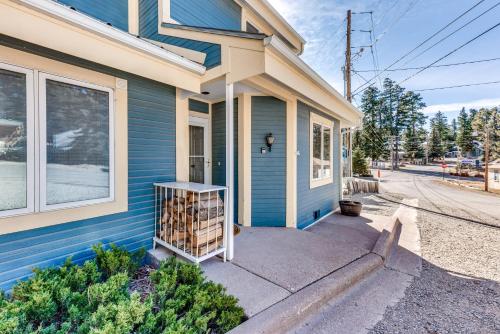 a blue house with a shelf of wine bottles at Bright Townhome - 1 Mile to Downtown Cloudcroft in Cloudcroft
