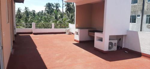 a room with a balcony with a tv on a building at Villa De Santos Acapulco Playa Bonfil Alberca in Acapulco