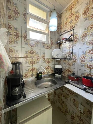 a kitchen with a sink and a counter top at SOL in Búzios