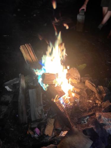 a fire pit with flames in the dark at Makins trap 