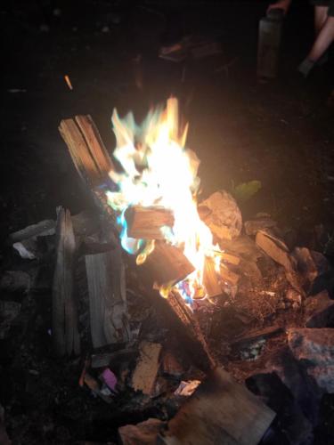a fire in a pile of garbage at night at Makins trap 