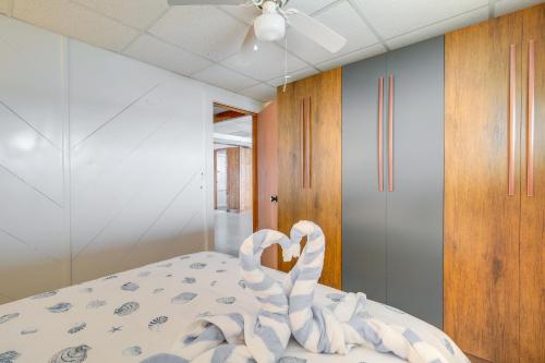 a bedroom with a bed with swans on it at Serene Mattapoisett Home with Private Beach Access! in Mattapoisett