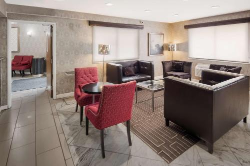 a hotel lobby with chairs and a table and a couch at Best Western Riverside Inn in Danville