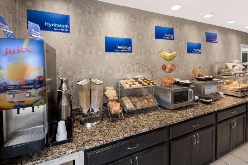a kitchen with a counter with a buffet of food at Best Western Riverside Inn in Danville