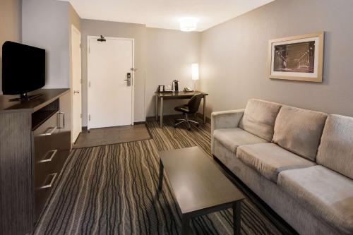 a living room with a couch and a table at Best Western Riverside Inn in Danville
