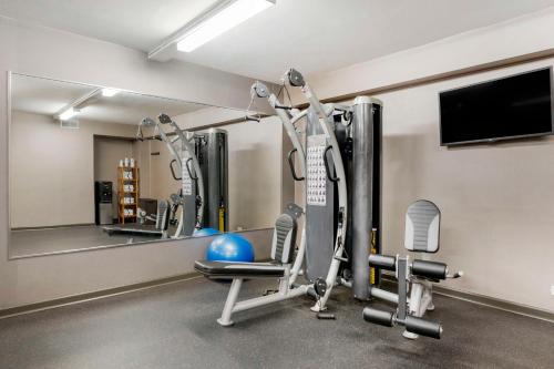 a gym with several tread machines and a mirror at Best Western University Inn at Valparaiso in Valparaiso