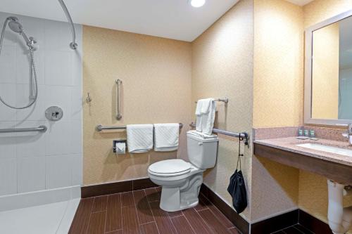 a bathroom with a toilet and a shower and a sink at Best Western University Inn at Valparaiso in Valparaiso