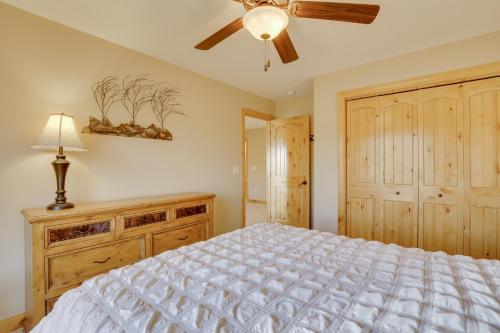 a bedroom with a bed and a ceiling fan at Hot Tub and Golf Course Views Luxe Sturgis Home! in Sturgis