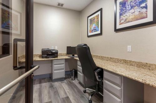 a room with a desk with a computer and a chair at Best Western Sycamore Inn in Sycamore
