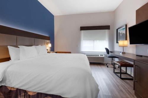 a hotel room with a large bed and a desk at Best Western Sycamore Inn in Sycamore