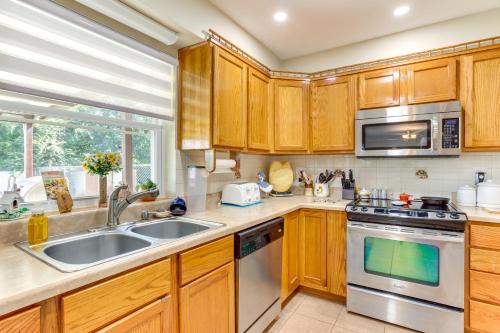a kitchen with wooden cabinets and a sink at Cozy Oklahoma Retreat with Covered Patio and Gas Grill in Mustang