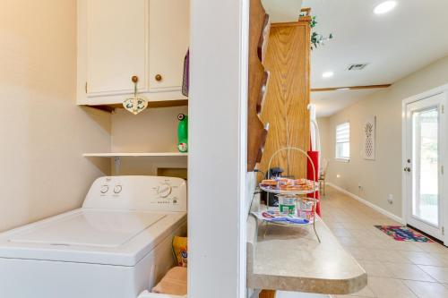 a kitchen with a washer and dryer in a room at Cozy Oklahoma Retreat with Covered Patio and Gas Grill in Mustang