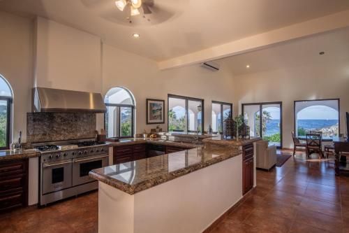 a large kitchen with a large island and windows at Rancho Las Cruces in Las Cruces