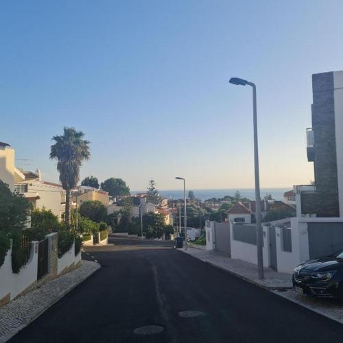 an empty street in a residential neighborhood with houses at Kubata T1 in Parede