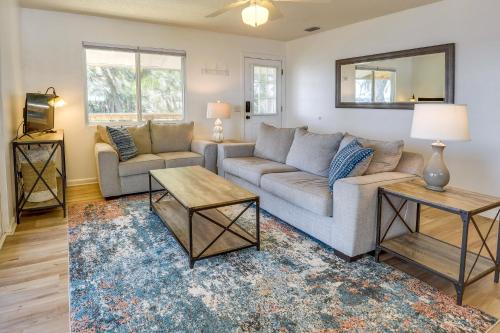 a living room with a couch and a table at Renovated Crescent Lake Escape with Waterfront Deck! in Crescent City