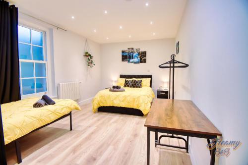 a bedroom with two beds and a table at Amazing place in Finsbury Park in London