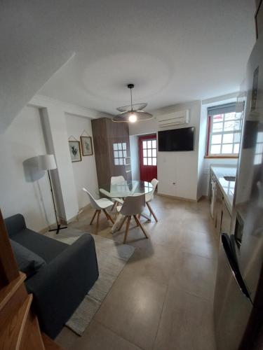 a living room with a couch and a table at TORREÃO HOUSE in Guarda