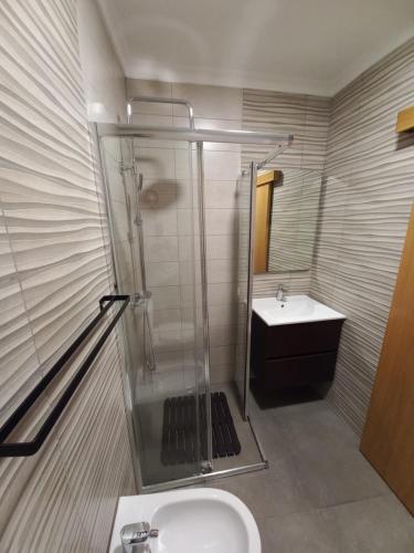 a bathroom with a shower and a sink at TORREÃO HOUSE in Guarda