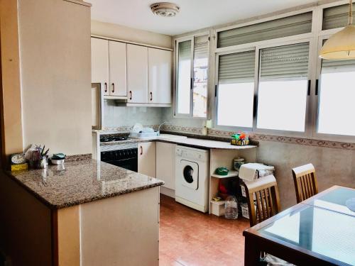 a kitchen with white cabinets and a dishwasher at Private SINGLE room in RUZAFA, ladies only, non smoker in Valencia
