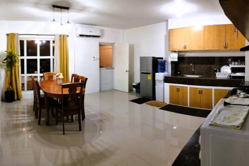 a kitchen and dining room with a table and chairs at Stellar Homesharing (Home #2) in Davao City