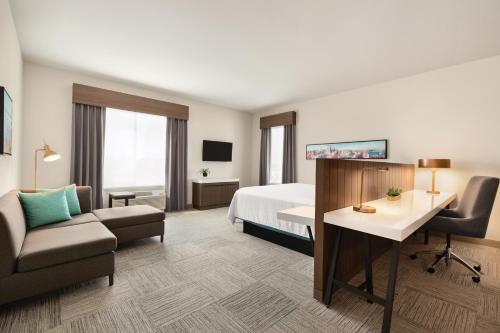 a hotel room with a bed and a desk at Hilton Garden Inn Seattle Airport in SeaTac