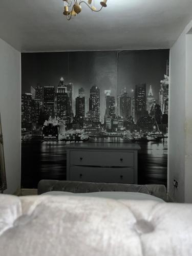 a bedroom with a view of a city skyline at Home 2 Home in London