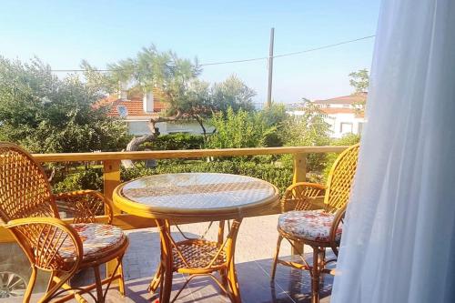 a table and chairs on a balcony with a table at Deniz ve Doğa iç içe Tatil in Ayvalık