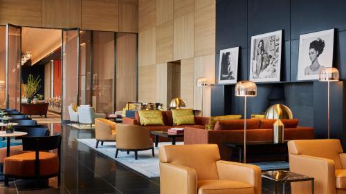 a lobby of a hotel with couches and chairs at Bvlgari Hotel Tokyo in Tokyo