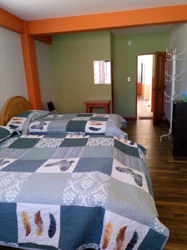 a bedroom with two beds with a quilt on them at Suma Qamaña in Copacabana
