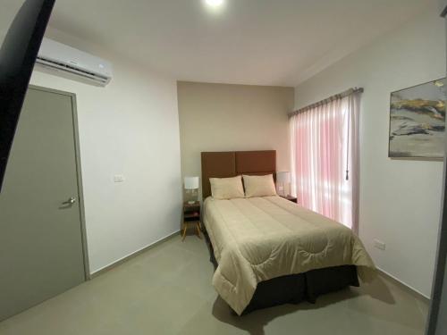 Ένα ή περισσότερα κρεβάτια σε δωμάτιο στο Departamento colonia Carrizal