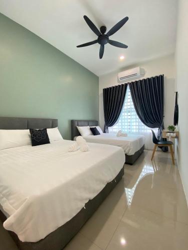 a bedroom with two beds and a ceiling fan at LYL HOMESTAY-IPOH 10Pax 4R in Ipoh