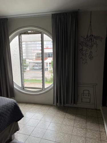 1 dormitorio con ventana grande y suelo de baldosa en Casa Cariño •Room 2•, en Ciudad Guzmán