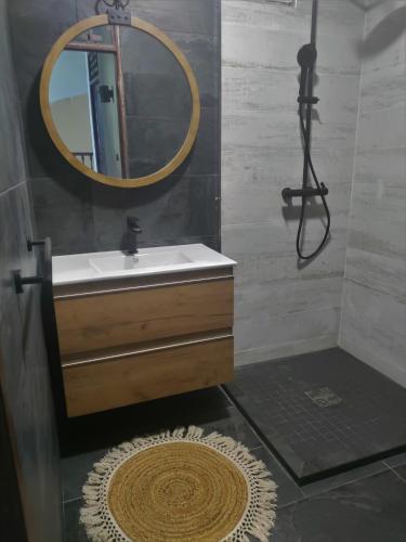 a bathroom with a sink and a mirror at Villa Gardenia in Kourou