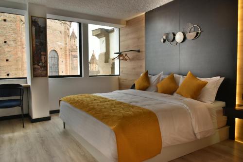 a bedroom with a large bed and a window at Hotel Vaway in Cuenca