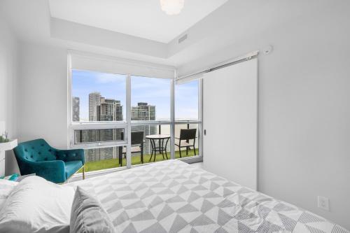 a bedroom with a bed and a view of the city at Luxury Downtown Toronto 2 Bedroom Suite with City and Lake Views and Free Parking in Toronto
