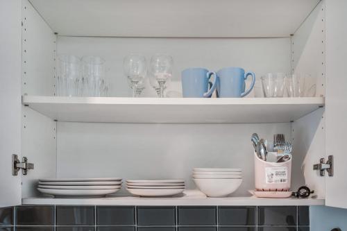 a kitchen shelf with plates and glasses and dishes at Luxury Downtown Toronto 2 Bedroom Suite with City and Lake Views and Free Parking in Toronto