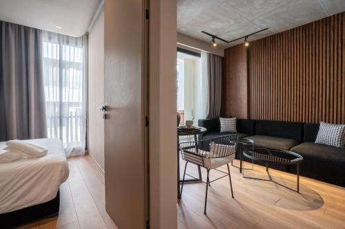 a hotel room with a bed and a living room at TWENTY SIX ANFA LUXURY RESIDENCE by Shortstaymaroc -Hyper Centre -Parking in Casablanca