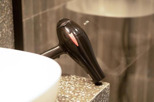 a black hair brush sitting on top of a counter at TWENTY SIX ANFA LUXURY RESIDENCE by Shortstaymaroc -Hyper Centre -Parking in Casablanca